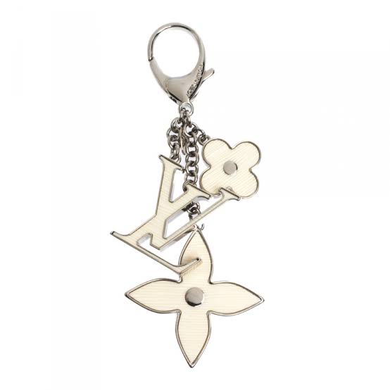 Silver keychain with floral designs on a white background