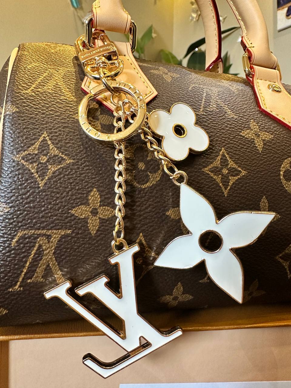  a keychain featuring a flower design on a handbag