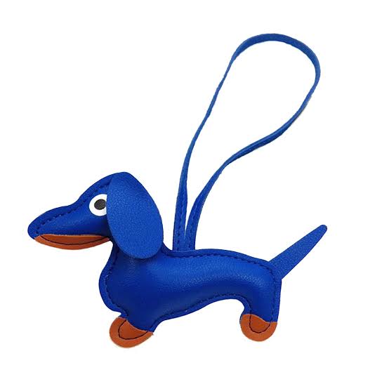 Blue dachshund-shaped keychain with a strap on a white background
